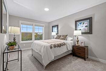 a bedroom with a bed and two windows